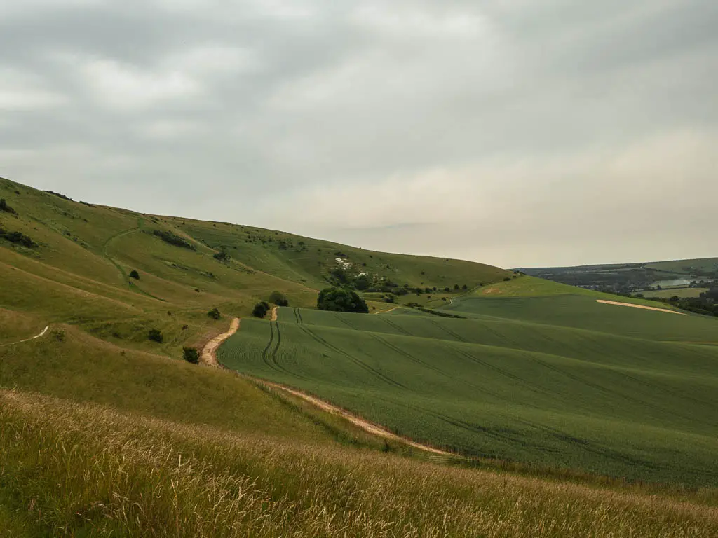 Looking across the rolling way hills towards the Long Man of Wilmington, on the circular walk in the South Downs.