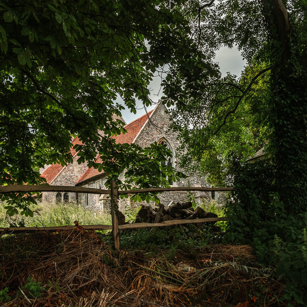 Looking through a gap in the trees to a church.