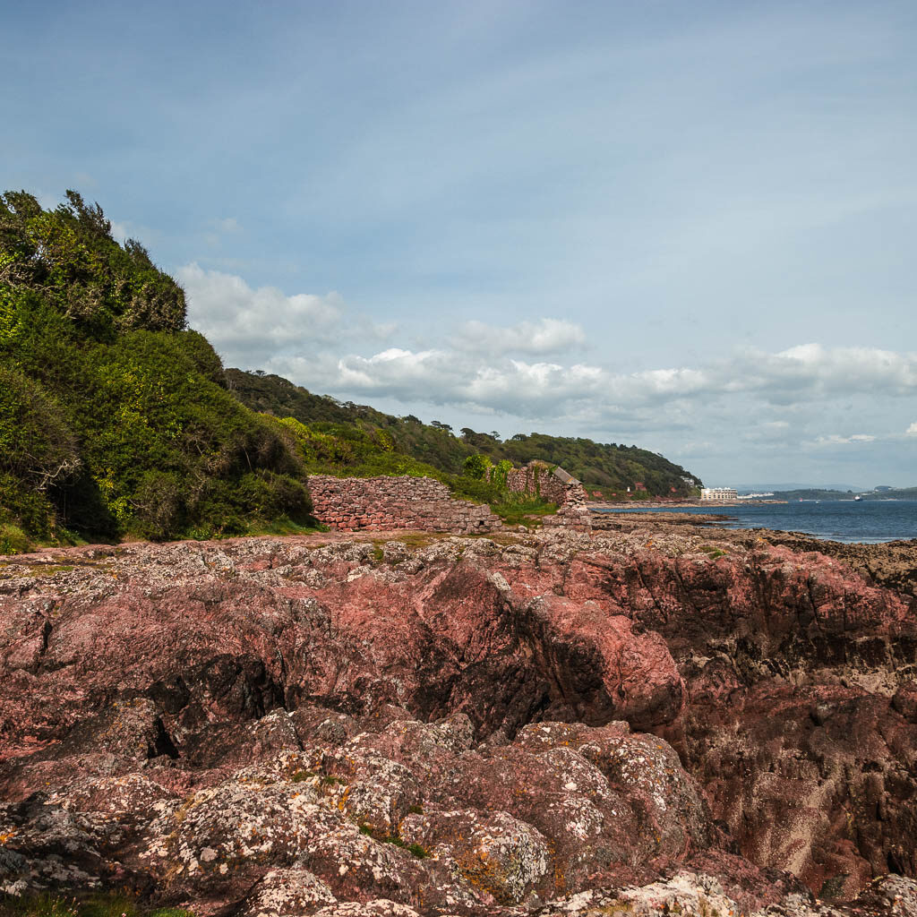 Looking across the rocks to the green bushy trees ahead and left.