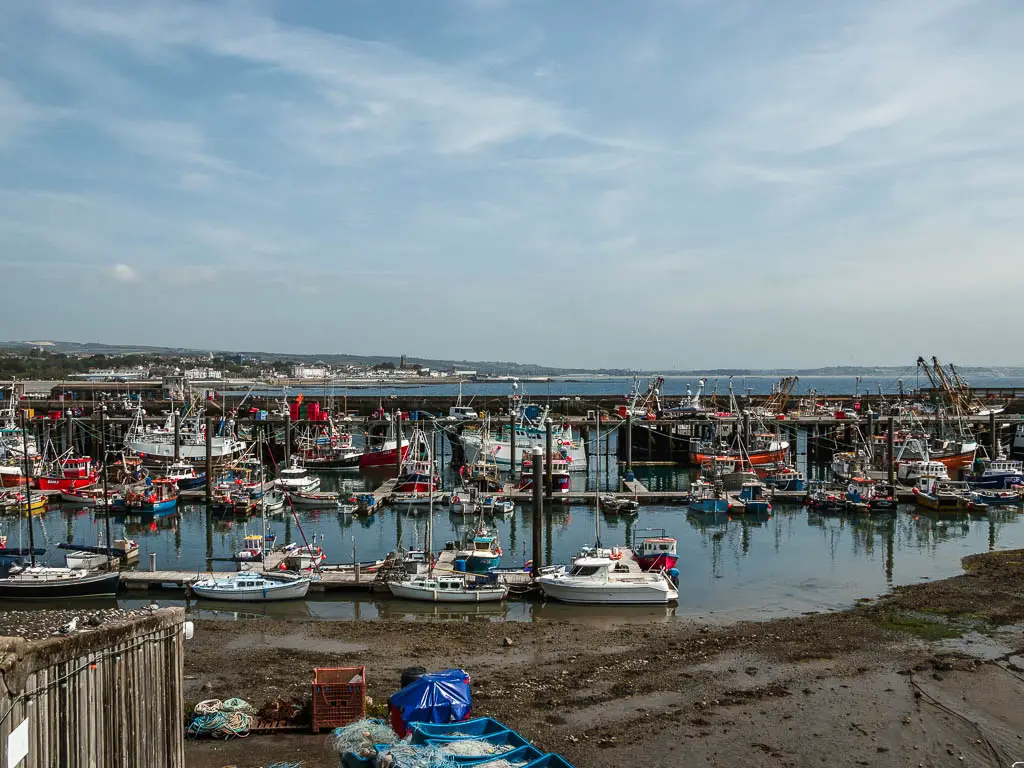 Looking across the harbour with the tide partially out. There are lots of boats in the water.