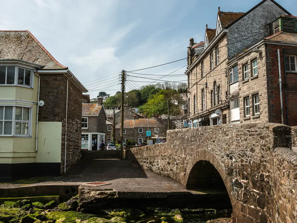 A stone bridge leading to houses on the other side, on the walk from Penzance to Mousehole.