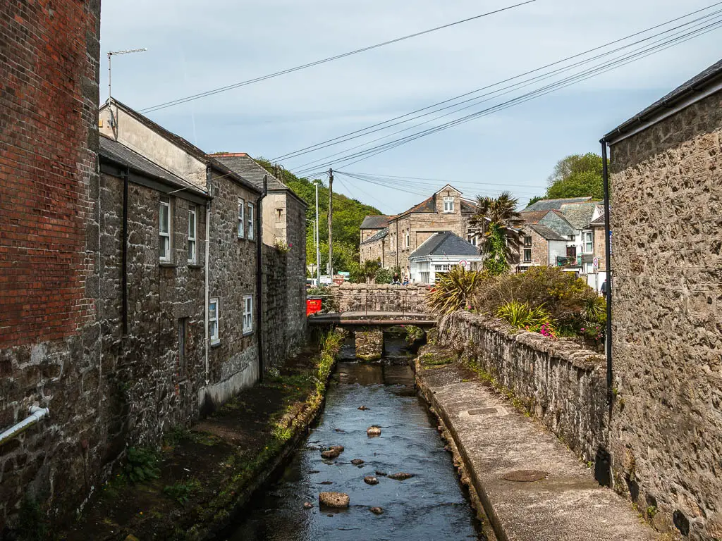 Looking along the stream running between the stone walled houses on the walk from Penzance to Mousehole.