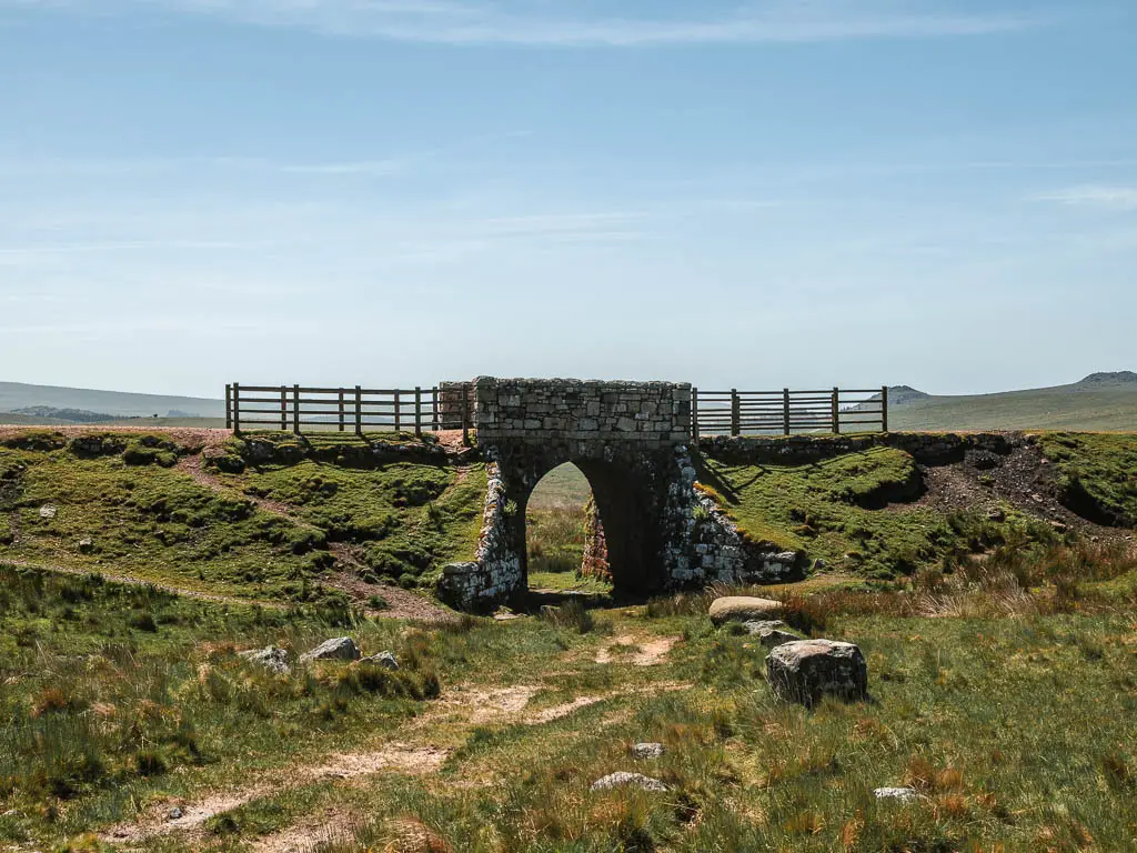 A stone archway bridge, within the moss and grass covered ridgeway.