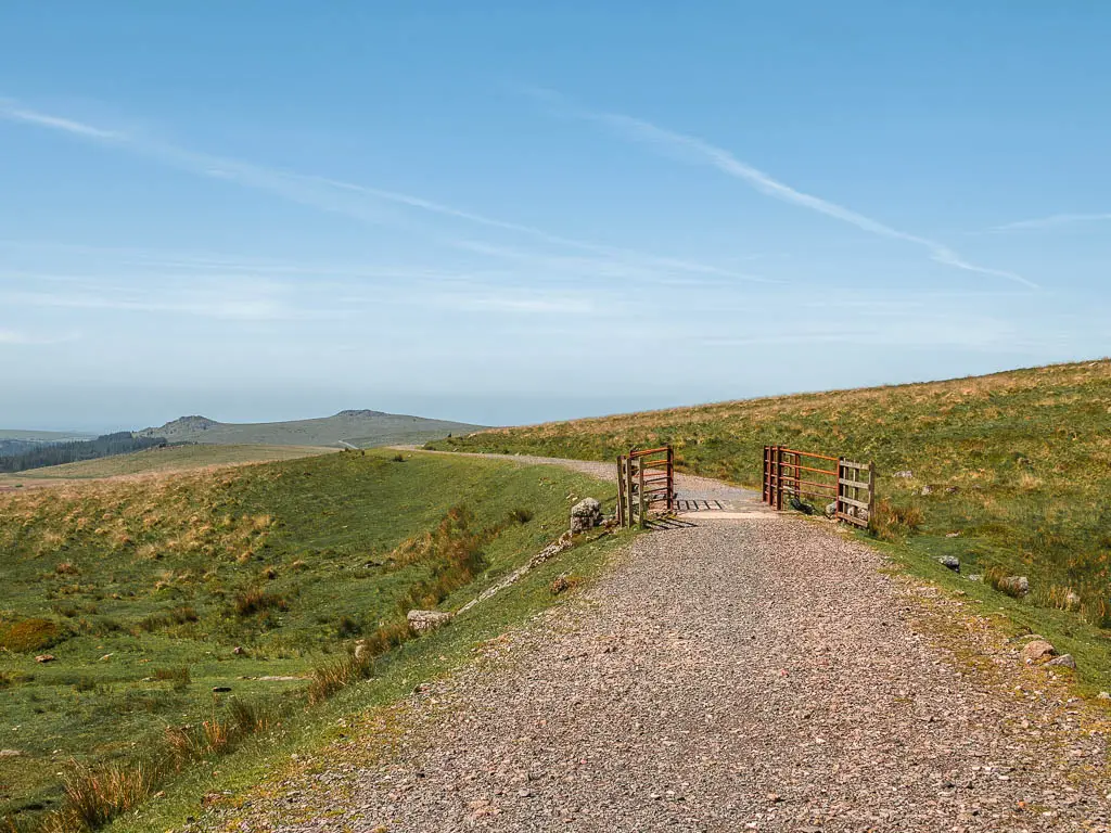 The gravel path of the Princetown Railway, on the walk to King's Tor. The path leading to a short bridge with metal railings.