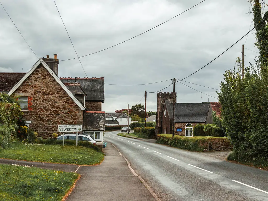 A main road leading into Yelverton, with houses on both sides of the road.