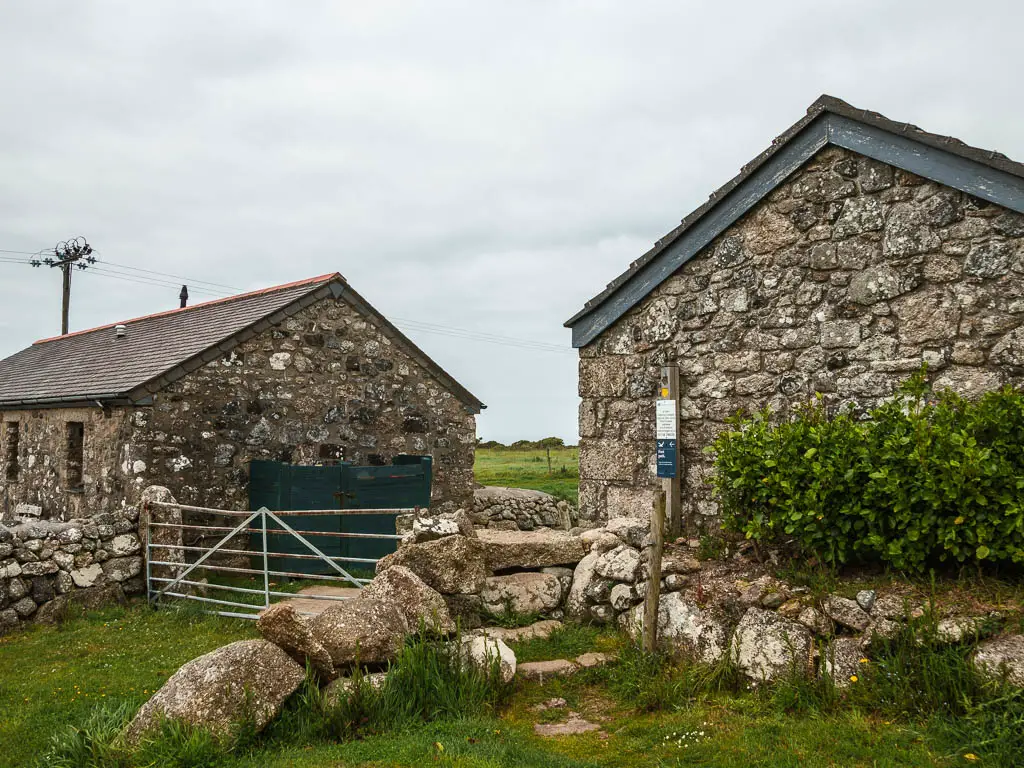 Stone steps to lead out of the field, with some stone buildings on the other side.