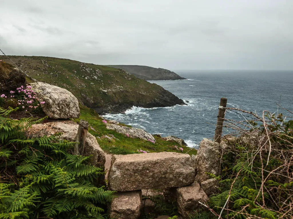 A rock stile with a view to the coastline on the other side as it forms couple of cliff peninsula's, along the walk from St Ives to Zennor on the coast path. 