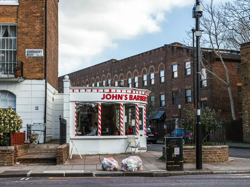 A corner barber shop in red and white.