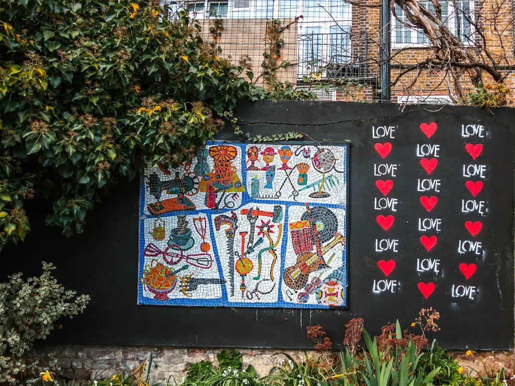 An art mural on the back wall, with red hearts and the word love.