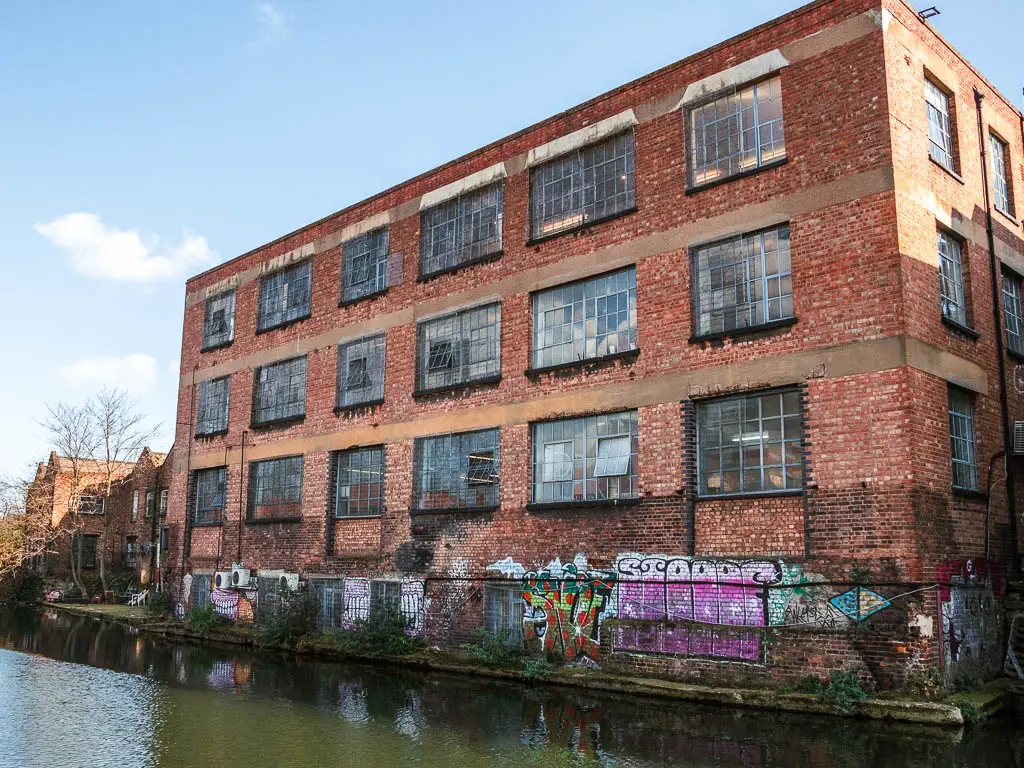 A large abandoned brick warehouse buildings on the other side of the Regents Canal, near the end of the walk.