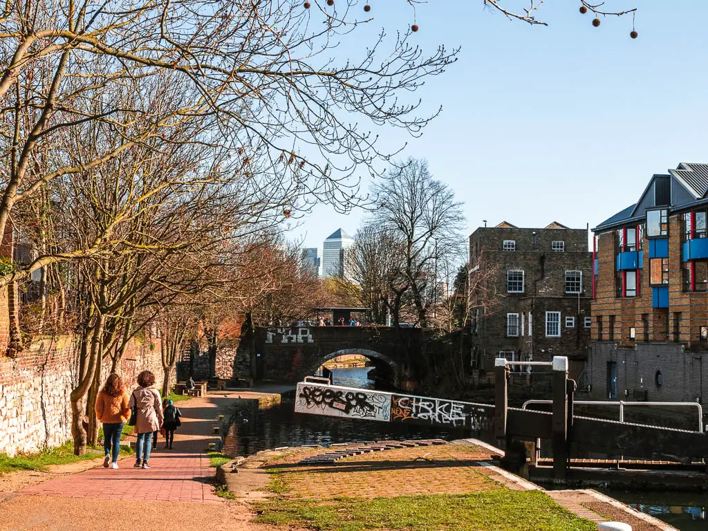 A view to the Canary Wharf skyscrapers through a gap in the trees when walking along the Regents Canal.