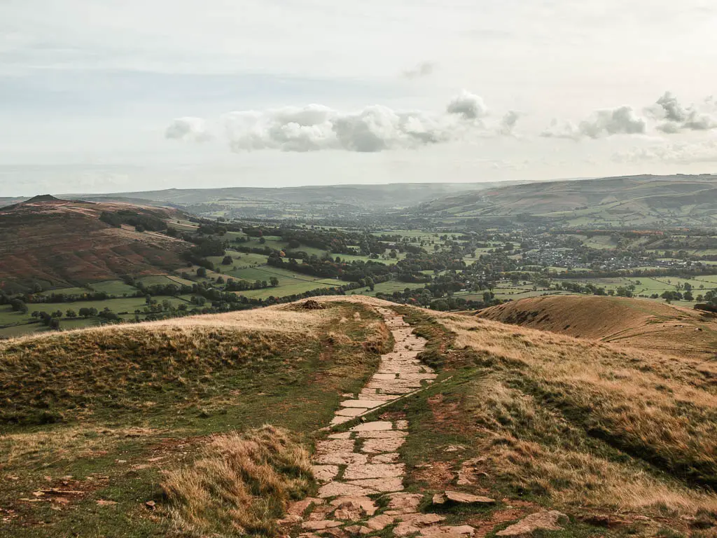 A stone paved path leading downhill to the valley.