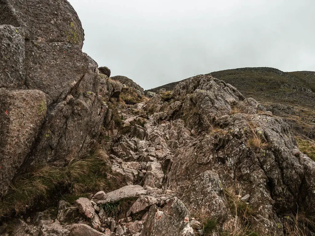 A big rock with a rocky route up it along the Old Man of Coniston walk.