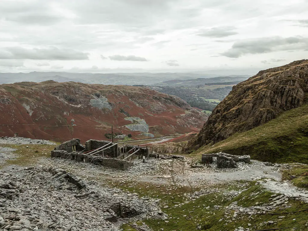 Mining building ruins surround by slate rocks.