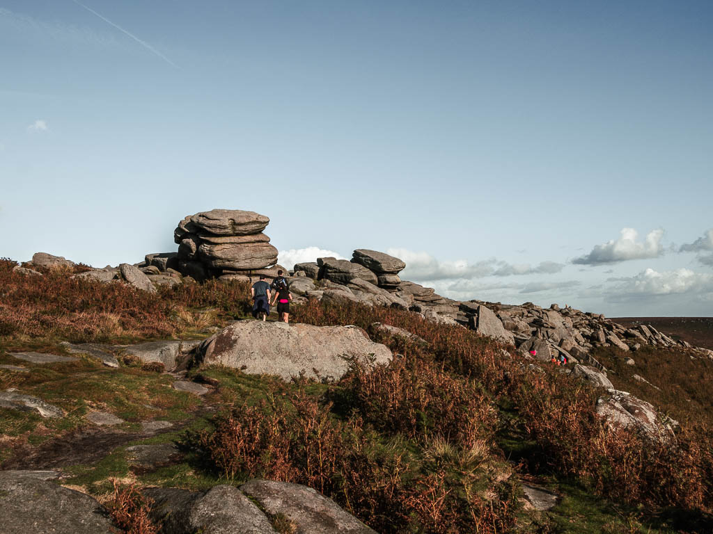 Stadning on top of Higger Tor, with stacks of rocks and boulders.