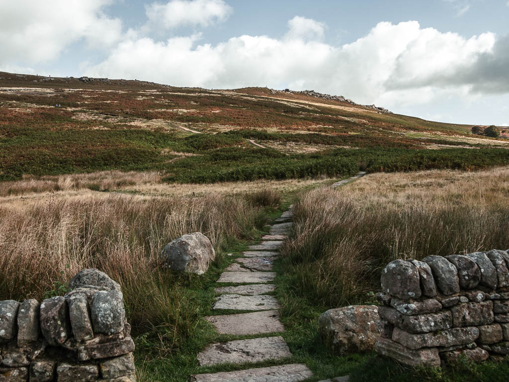 A paved stone path marking the start of the walk route to Stanage Edge.