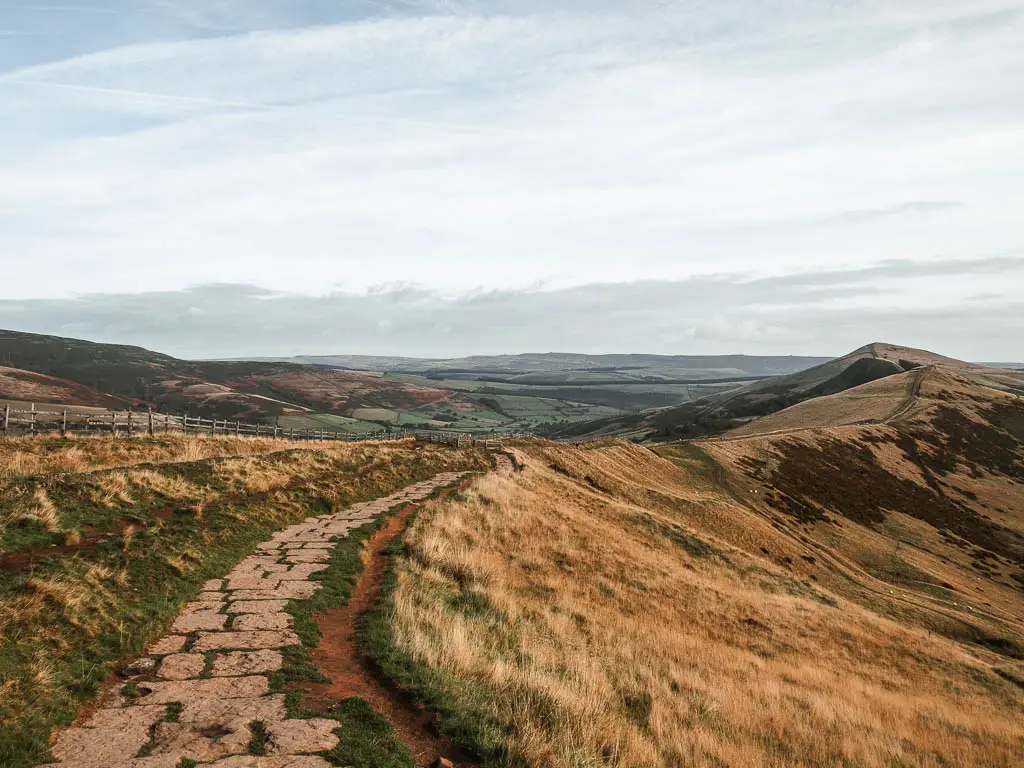 A long ridge with a paved stone path on one of the best walks in the Peak District National park. 