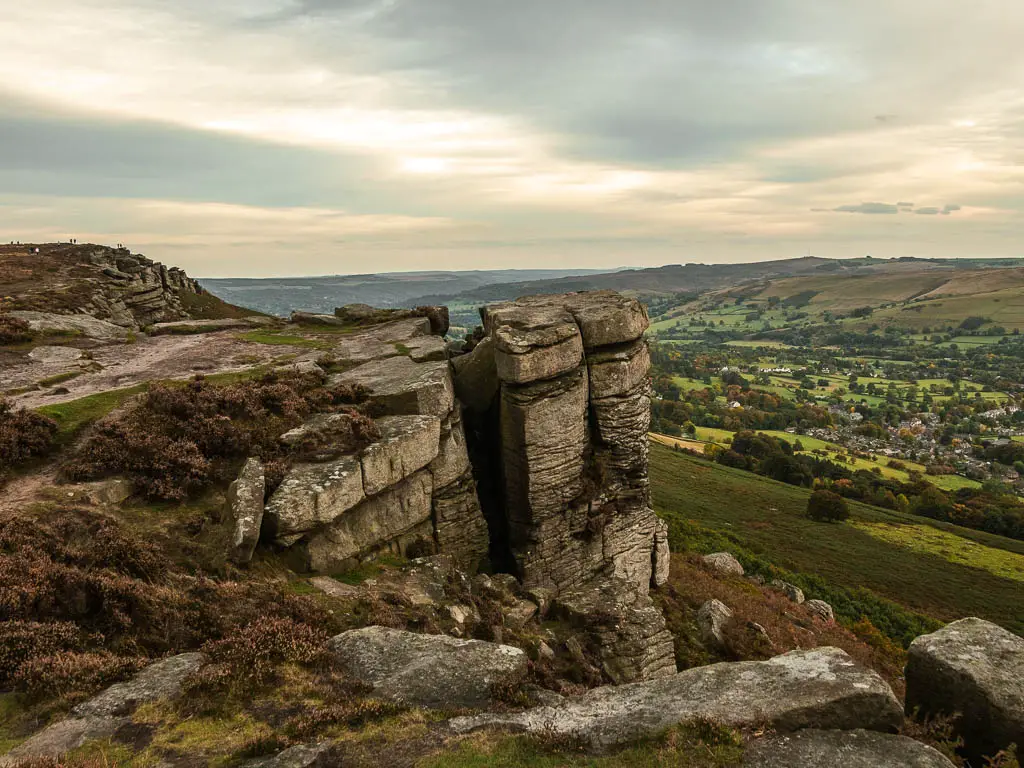 Looking down and along the rock face  of Bamford Edge with a view to the valley below.