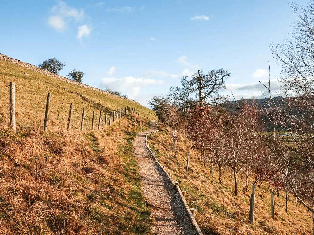 a thin gravel type path running along the side of a hill.