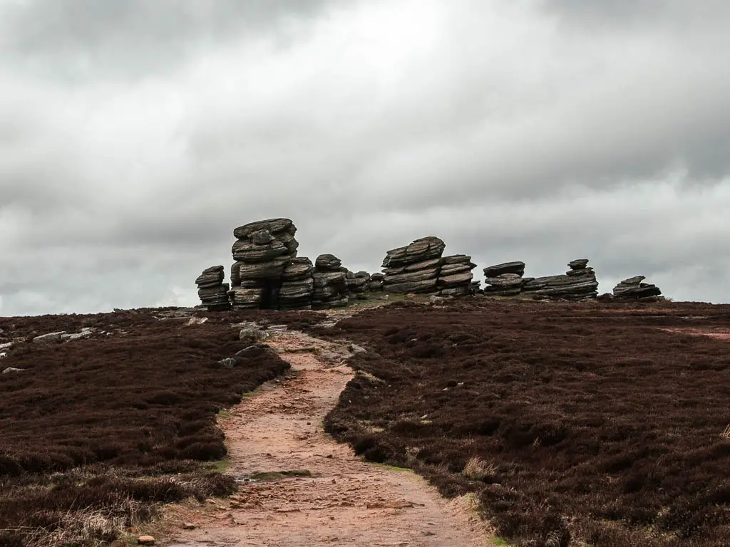 A trail leading to some big tors on the walk along the top of Derwent Edge in the Peak District.