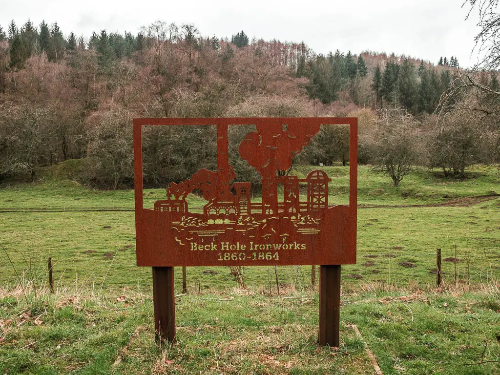 An iron plaque design showcasing the Beck Hole Ironworks, along the rail trail walk from Goathland to Grosmont.