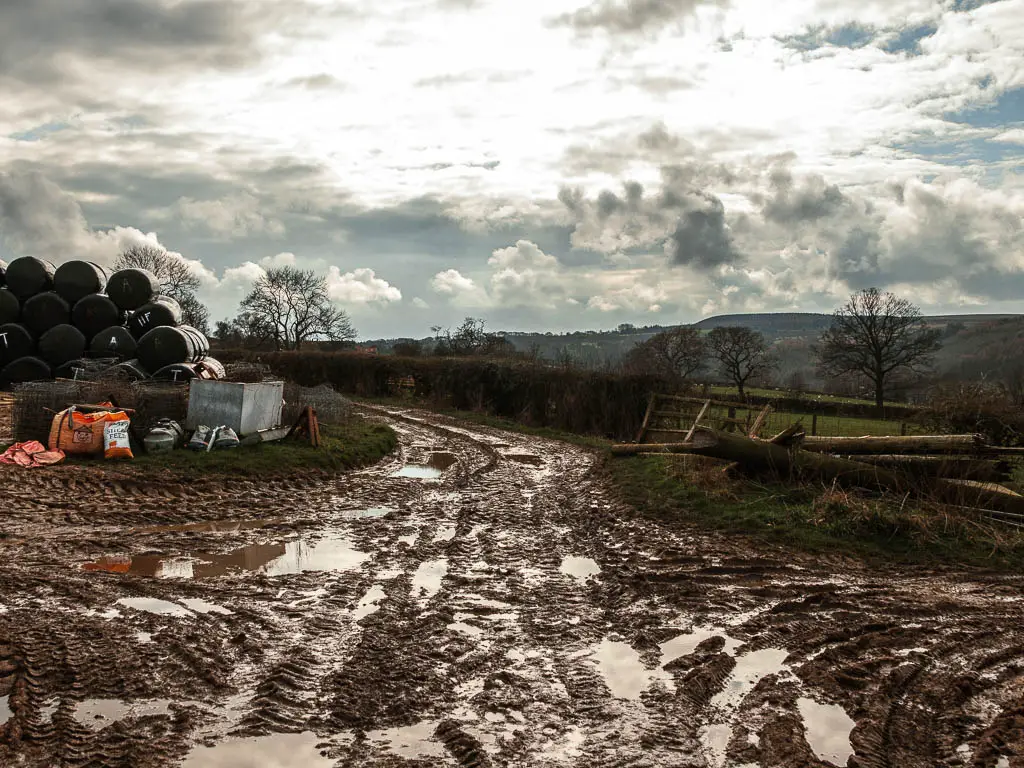 A very muddy path of ground through the farm. 