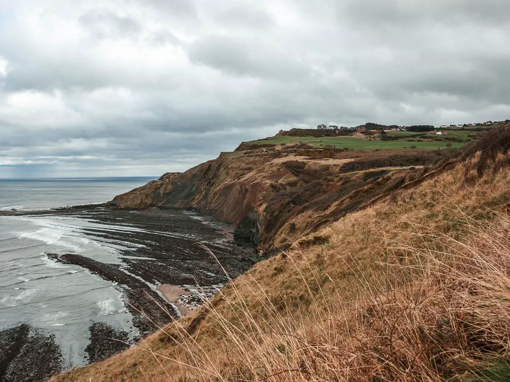 Looking down the hill to the sea and cliffs of Ravenscar, on the circular walk from Robin Hood's Bay.