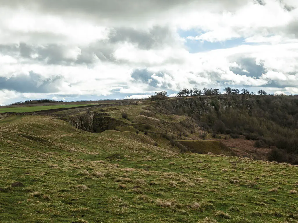 Looking along the hill top, the the rugged wavy hillside ahead.