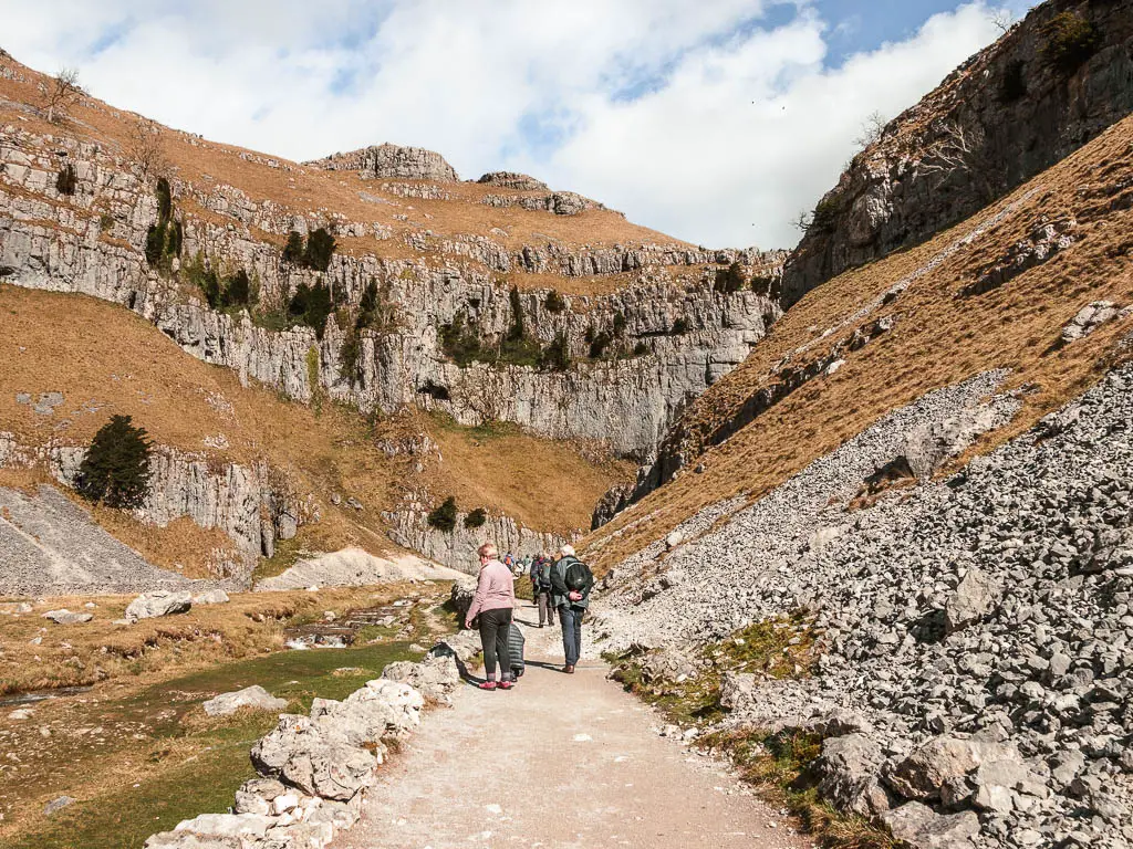 Lots of people on the path leading through the rocky gorge on the walk into Gordale Scar.