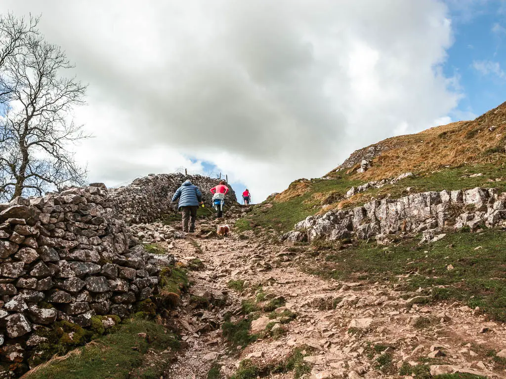 People walking up a rocky bit in the trail, on the walk towards Malham Cove.
