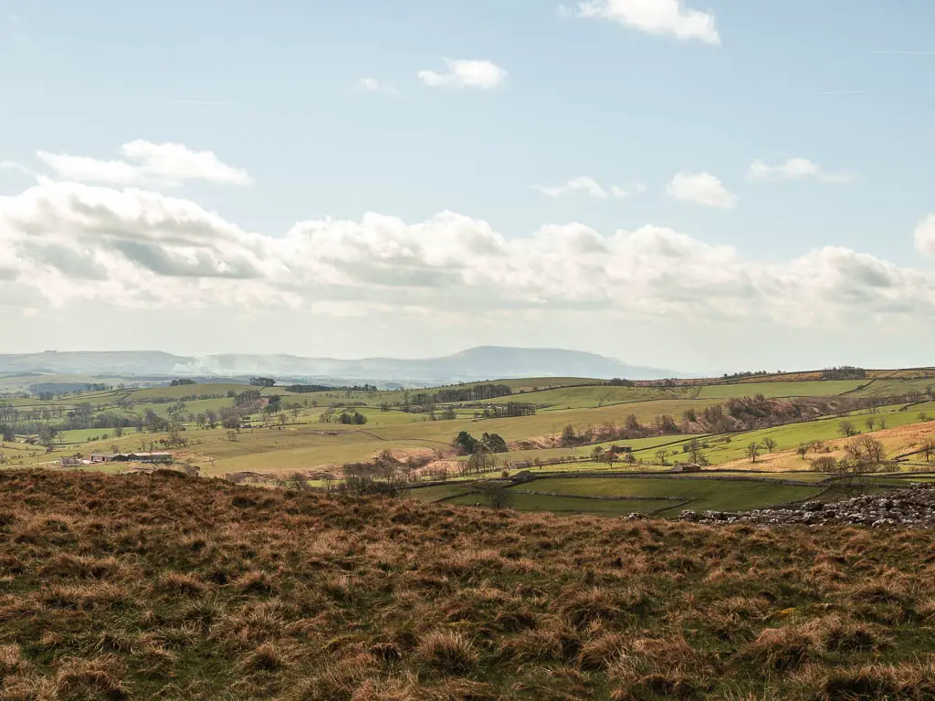 Looking across the fields, to a view of some big hills way in the distance.