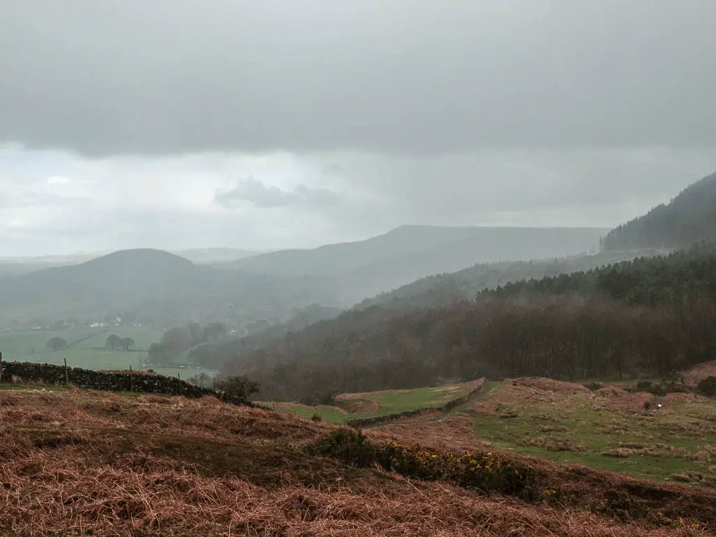 Looking down across the moor to a silhouette of hills way into the distance, part way through the walk from Osmotherley.