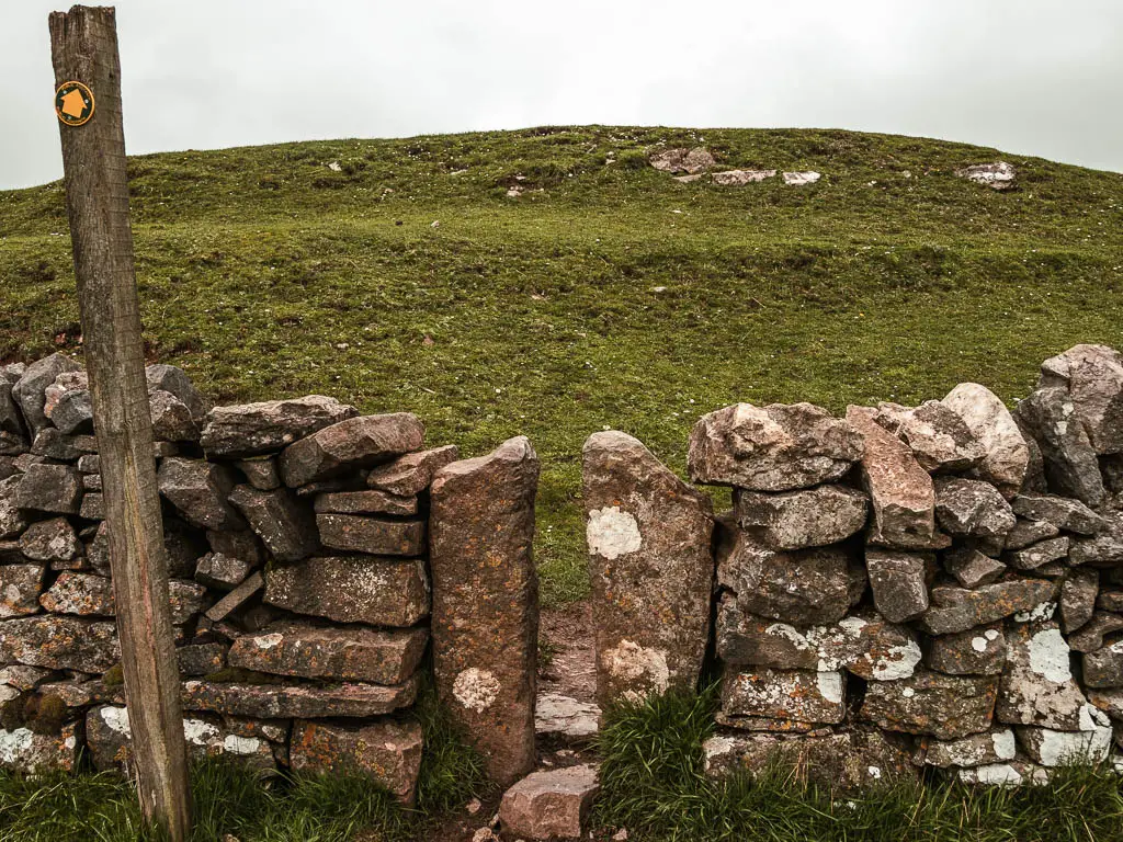 A tiny gap in the stone wall. 