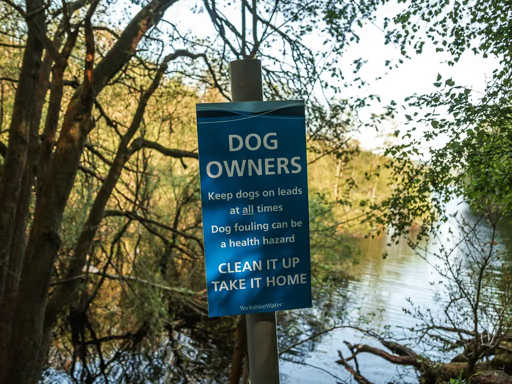 A blue sign warning dog owners to keep their dogs on leads.