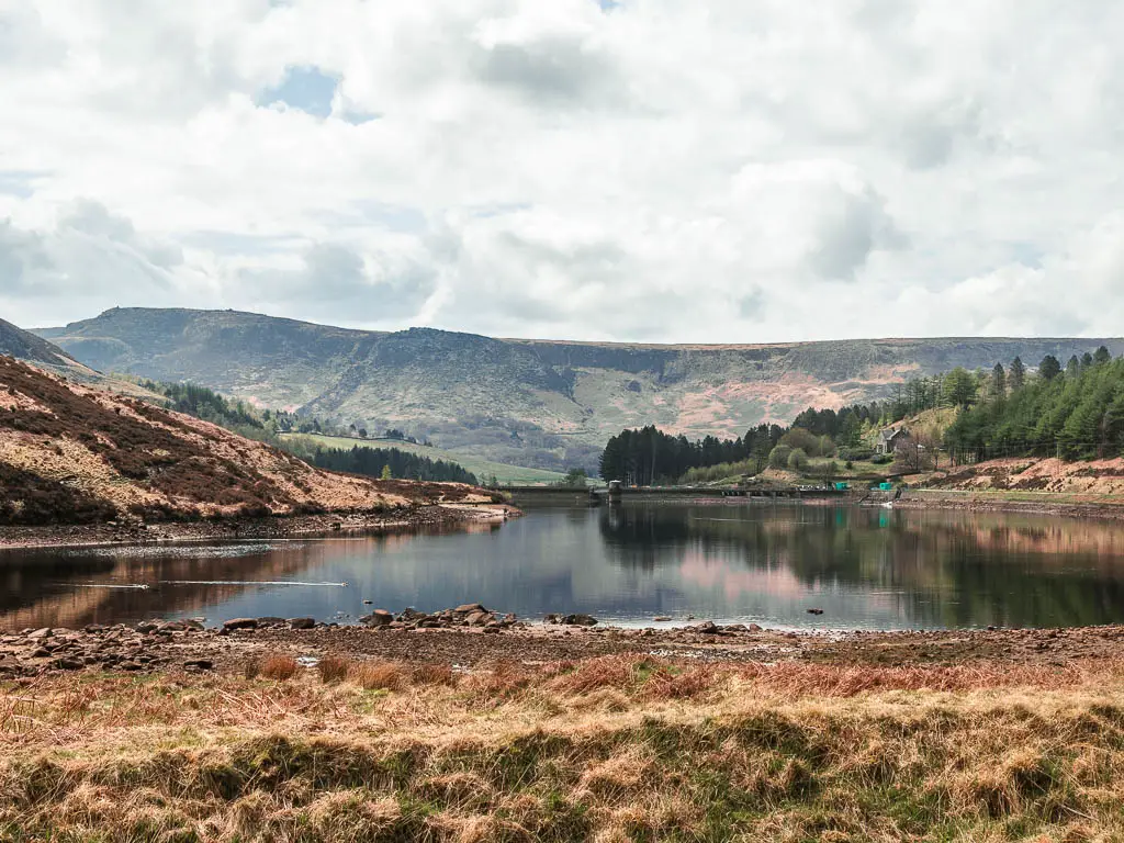 Looking across the wild grass towards Yeoman Hay Reservoir, and a biog hill rising up in the distance, half way through the walk.