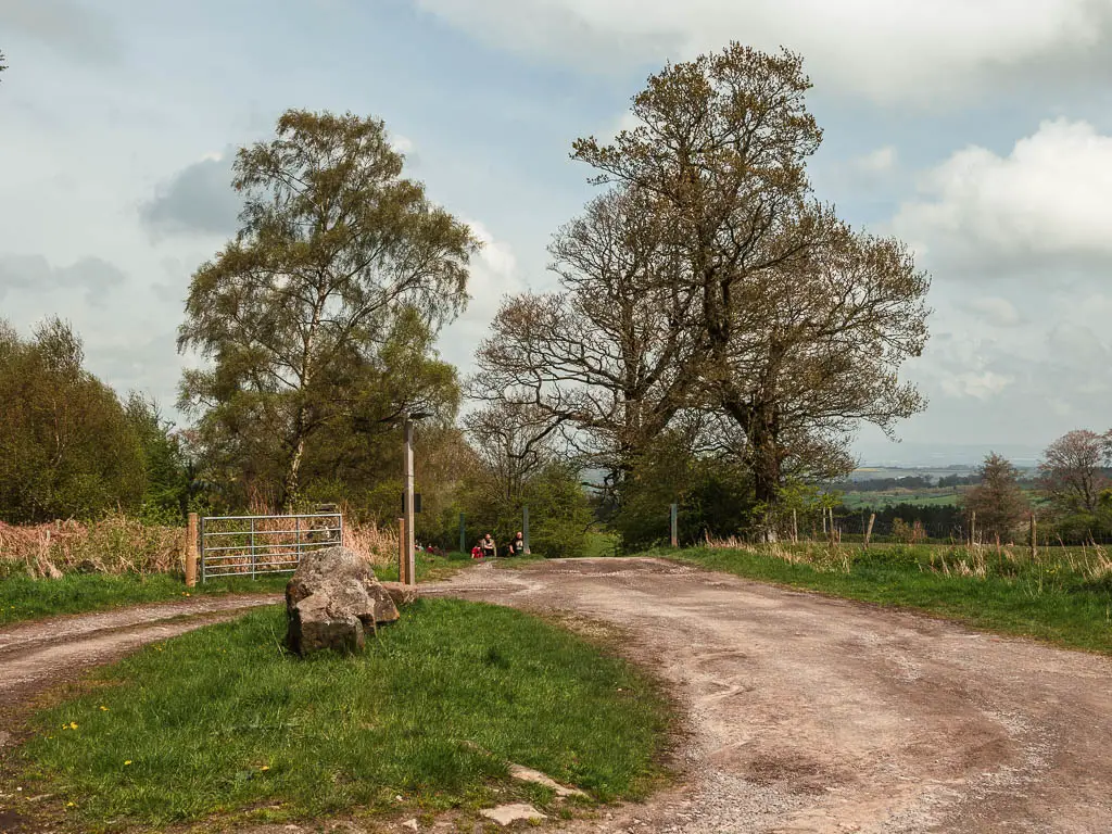 A road path circling around a small green.