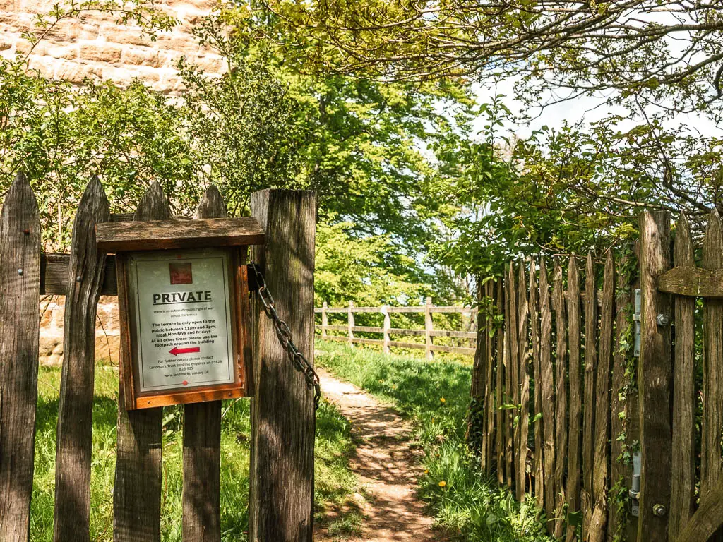 A wooden gate, with a sign saying 'private'.