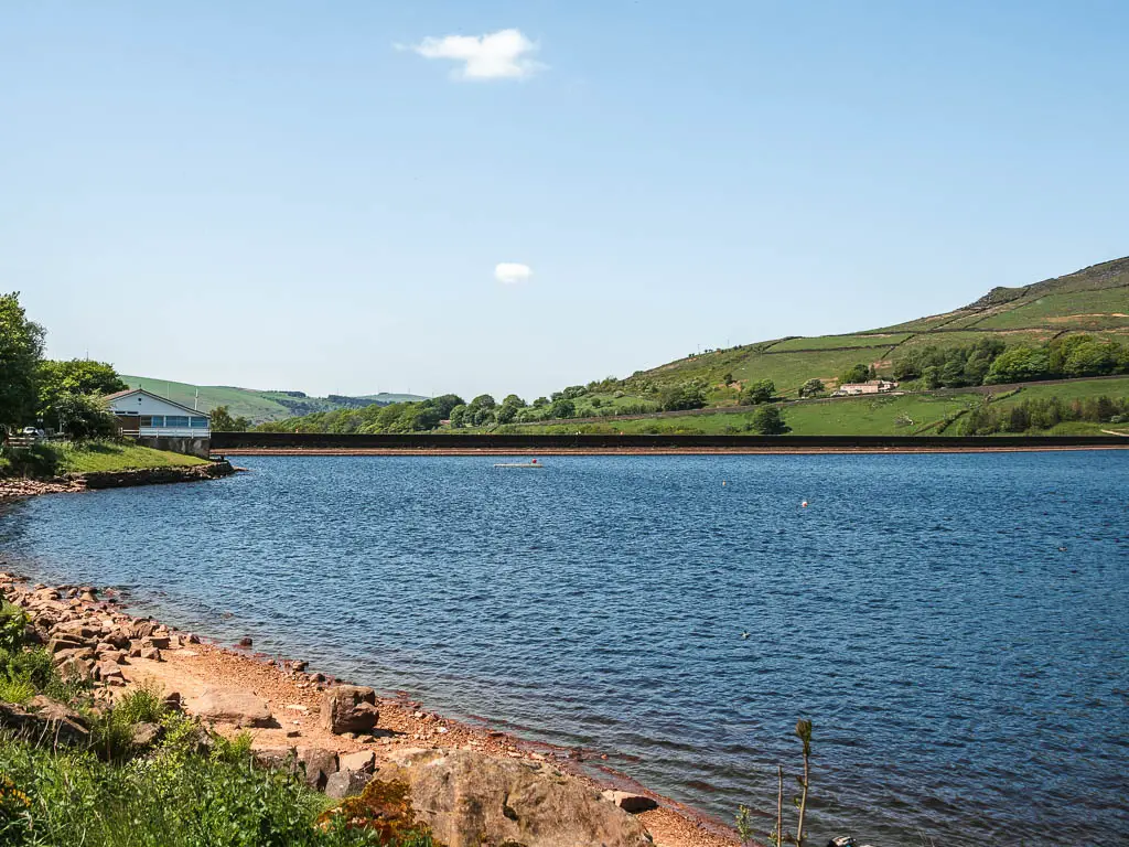 Looking across the reservoir with blue rippling water, at the end of the Trinnacle circular walk. 