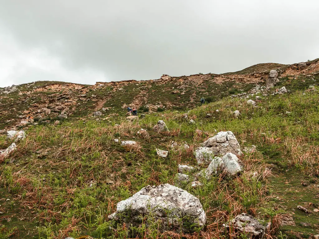 Looking up the rocky, grass hill.
