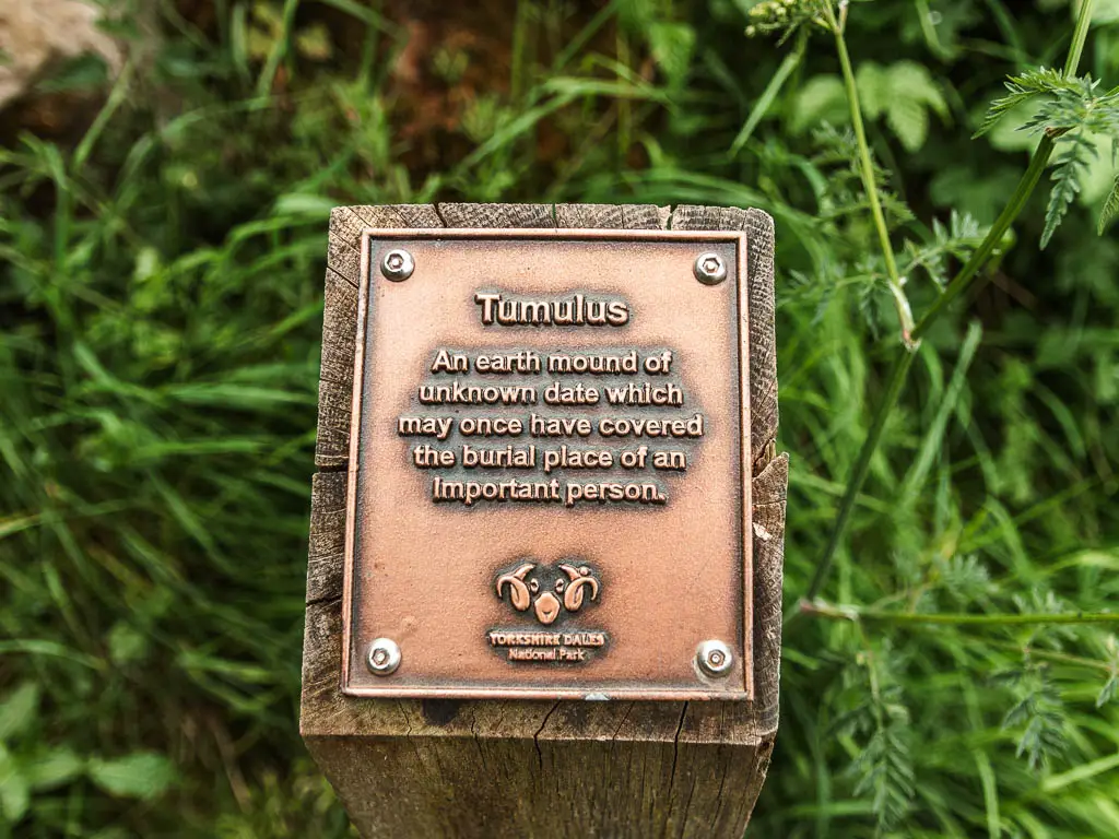 A copper plaque marking the burial place of an important person. 