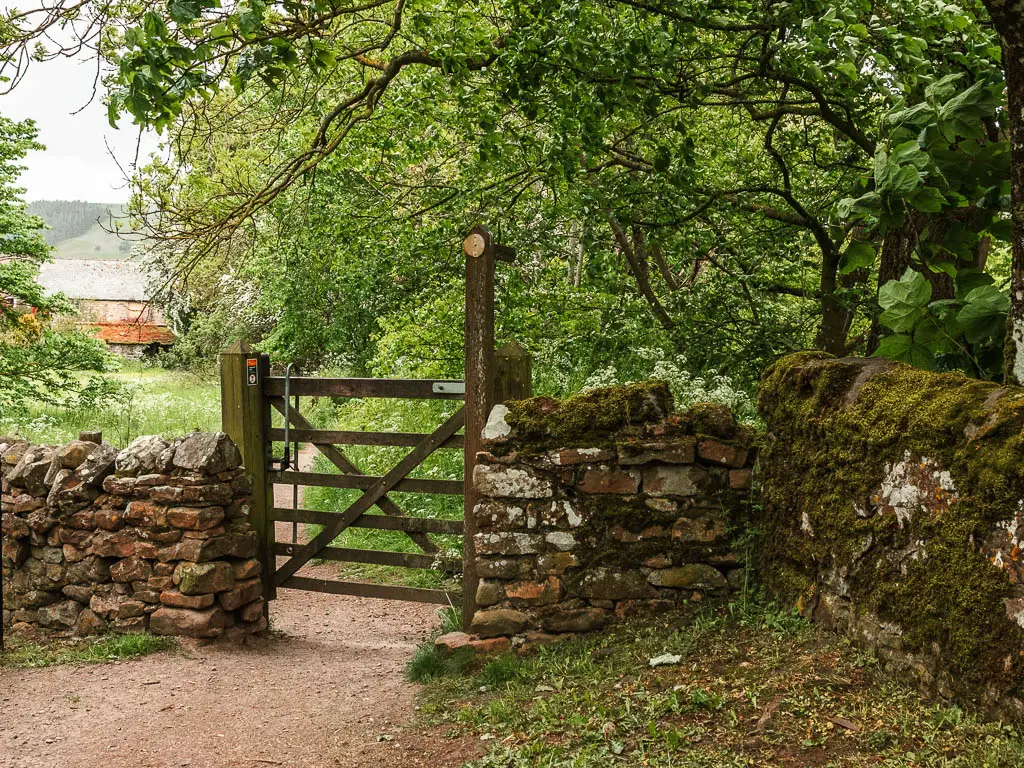 A wooden gate in the stone wall.