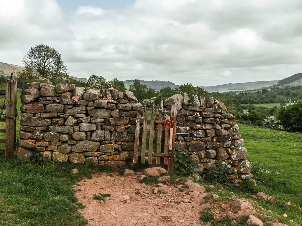 A wooden gate in a stone wall.