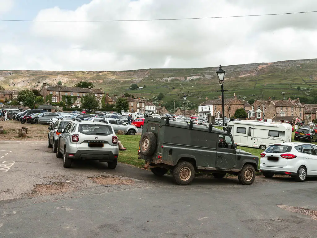 A mass of cars parked in the centre of Reeth.