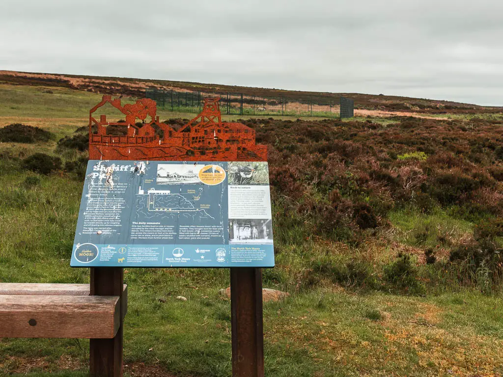 An information board with brown heather behind, when walking along the Rosedale Railway trail.