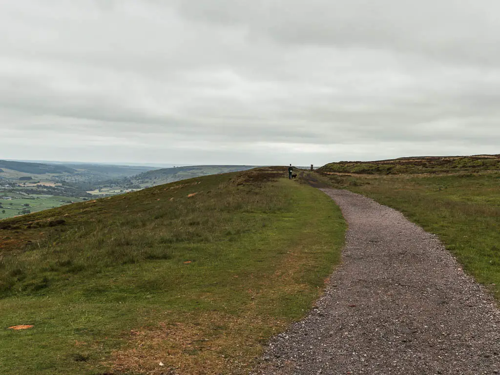 The gravel path of the Rosedale Railway, leading ahead through the grass hilltop.