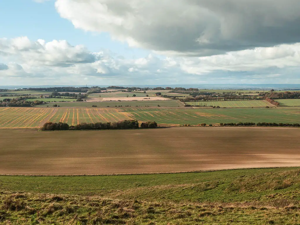 Looking down and across the expanse of crop and grass fields.