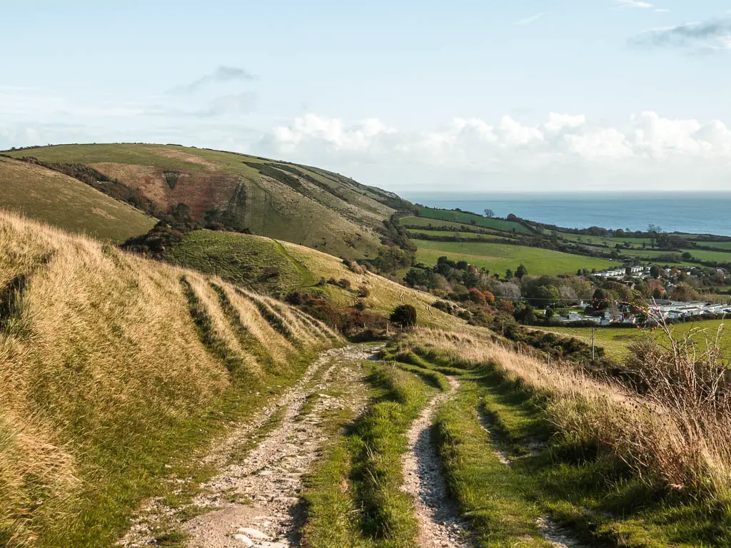 Looking down a rocky trail with underling hills to the left and ahead, on the walk towards Swanage from Corfe Castle.