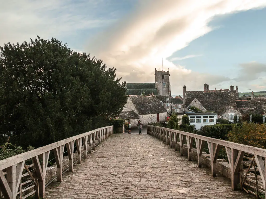 A stone walkway across the bridge, leading into Corfe Village at the end of the walk from Wareham.