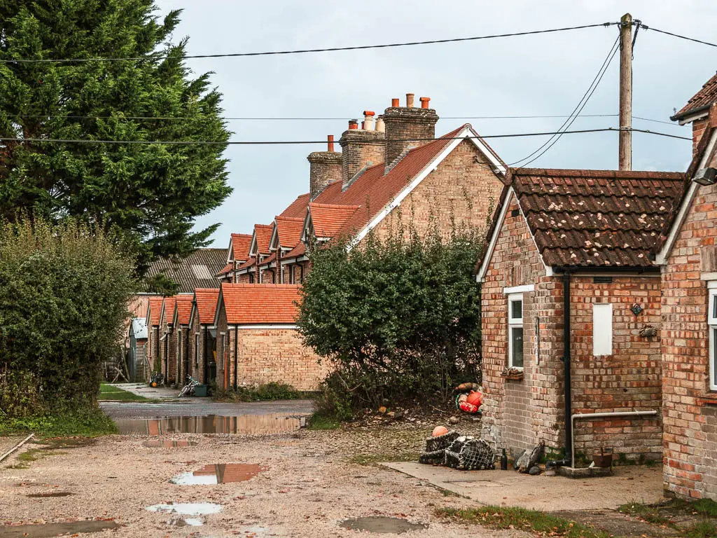 A row of uniform brick houses on the right.