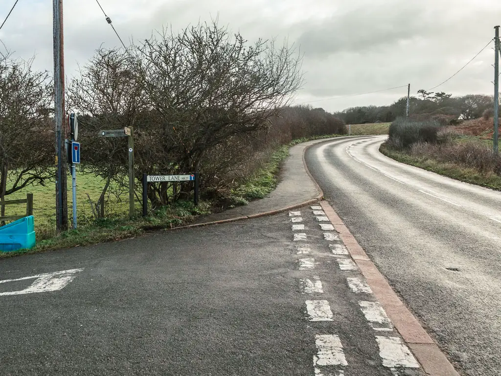 A road leading ahead and then curving right, with a side road to the left. 